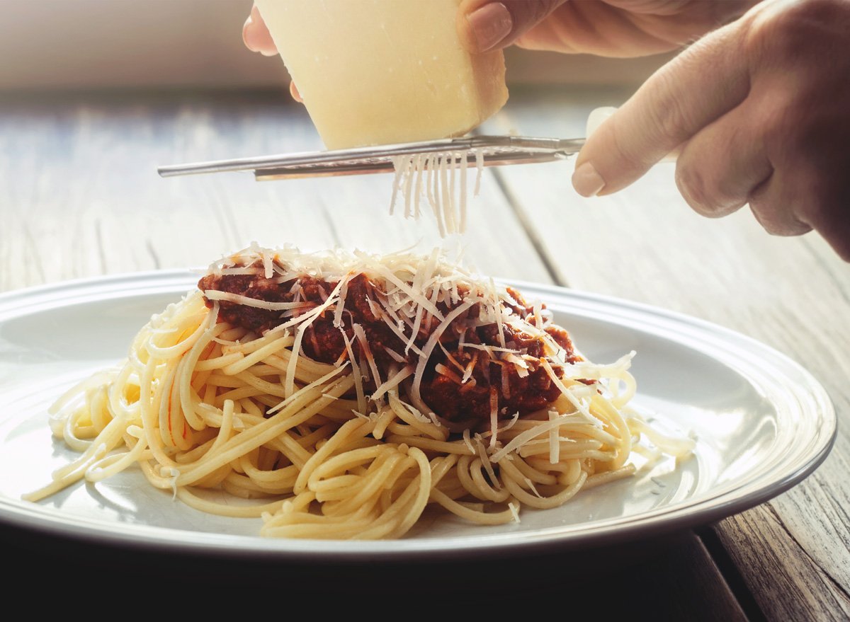 grating parmesan cheese pasta red sauce